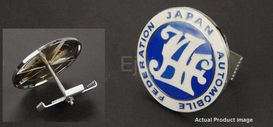 The blue badge on the front of the car grille belongs to the Japan Automobile Federation and is applicable to for Mazda .